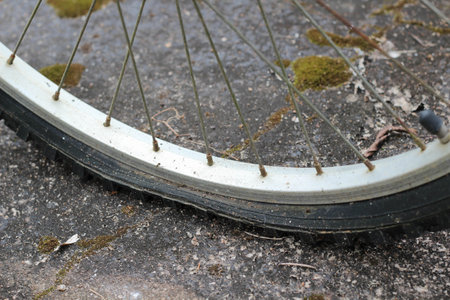 An old wheel bicycle flat tire on concrete floorの写真素材
