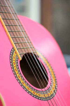 A pink acoustic guitar close-upの写真素材