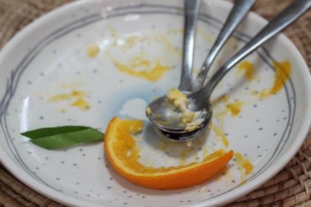 A white empty plate with spoons after eating