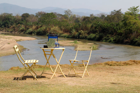 The empty table and chairs for two people set, outdoor by the riverの写真素材
