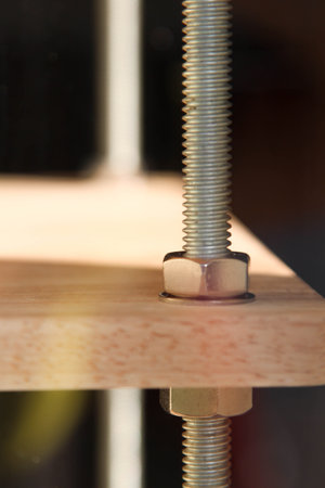 Screw and nut on  wooden surfaceの写真素材