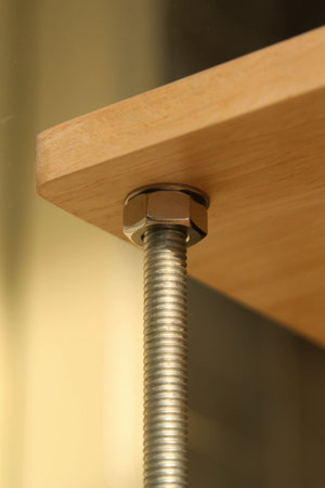 Screw and nut on  wooden surfaceの写真素材