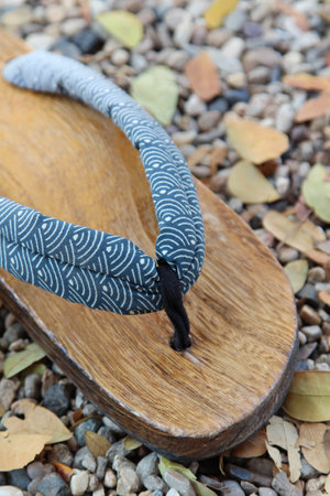 Traditional Japanese wood sandals on the gravel floorの写真素材