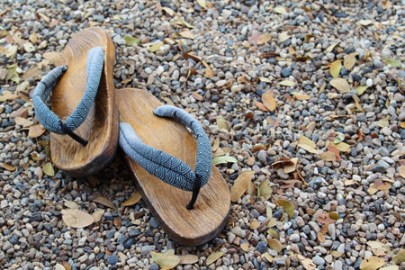 Traditional Japanese wood sandals on the gravel floorの写真素材