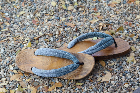 Traditional Japanese wood sandals on the gravel floorの写真素材