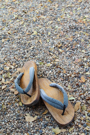 Traditional Japanese wood sandals on the gravel floorの写真素材
