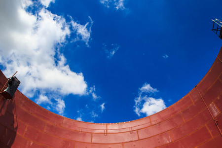 Storage tank oil about  wall  of tank production petroleum refinery  sky blue
