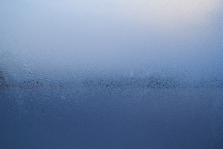 Steam on glass caused by moisture and background.
