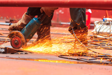 Male  worker wearing protective clothing and repair grinding industrial construction oil and gas or  storage tank inside confined spaces.の写真素材