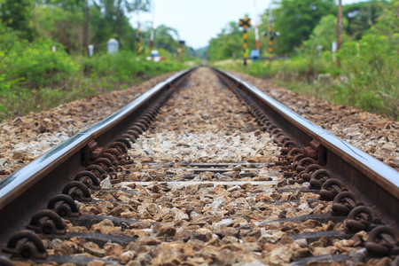 Railroad tracks an old worn wooden structure. Railway lines. Merging railroad tracks. Railway arrow translation movement. Selective focus with shallow depth of fieldの写真素材