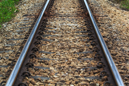 Railroad tracks an old worn wooden structure. Railway lines. Merging railroad tracks. Railway arrow...