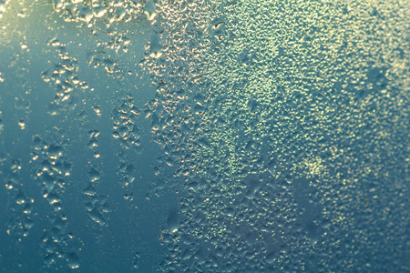 Steam on glass caused by moisture and background.の写真素材