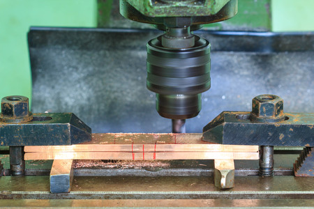 milling press drilling a copper plate. A fast shutter was used. Focus is on the point where the...