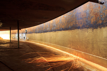 Welding steel roof storage tank sparks heat  confined.