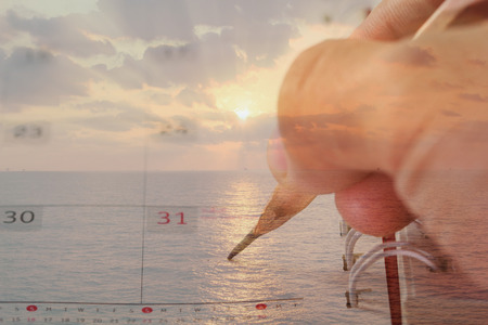 Double exposure of Note book with pencil  - sea at sunset backgroundの写真素材