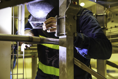 Male  worker wearing protective clothing of Repair pipe argon  welding industrial constructionの写真素材