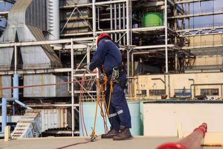 Male worker standing on tank roof  before working safety on rope access of inspection storage tank