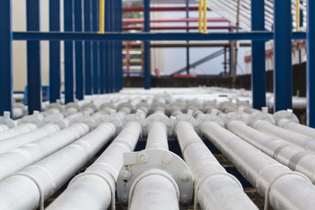 pipeline  white flange flowing oil and gas production petroleum refineryの写真素材