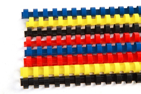 colorful plastic multi-ring paper binding spine on white backgroundの写真素材