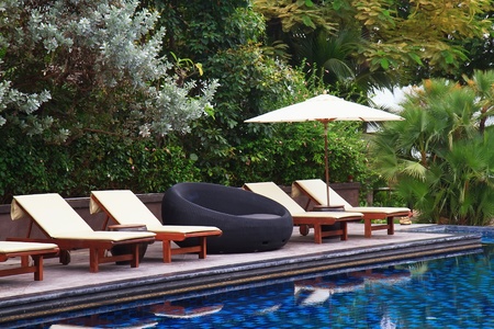 Beach beds among palm trees at perfect tropical coast