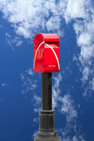 red postbox with blue skyの写真素材