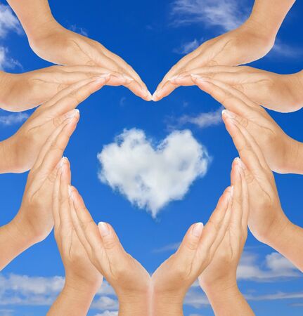 Heart in hand, heart-shaped cloud.の写真素材