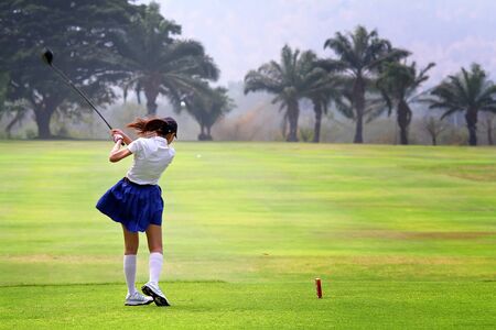 female golf player with a golf clubの写真素材