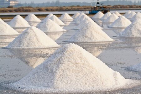 Salt fields with piled up sea salt in Thailand