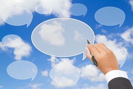  Businessman  writing  text balloon on blue skyの写真素材