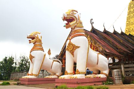 two lion guard statues in Thai temple, Sangklaburi, Kanchanaburi, Thailand