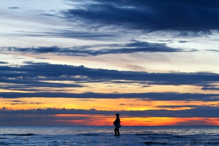 Silhouette image of fisherman walking in the huahin sea, Thailandの写真素材