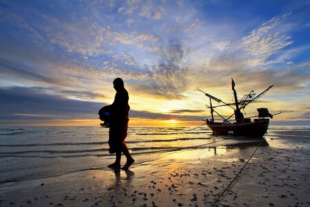 Early morning activity of monk on the beach at Huahin Thailand.の写真素材