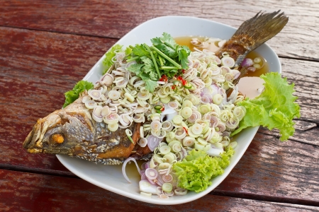 Herb salad with deep fried fish (Thai fusion and healthy food)の写真素材