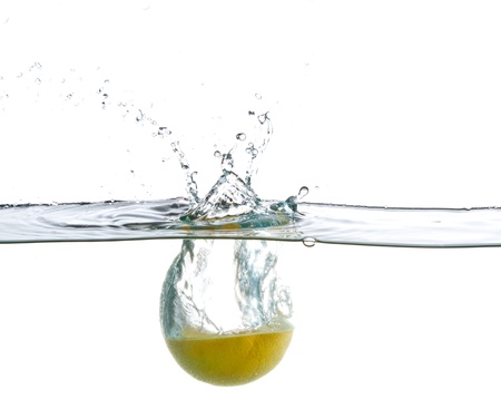 Orange splashing water isolated on whiteの写真素材