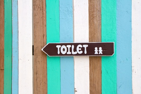 Toilet signs on the colorful wood wall backgroundの写真素材