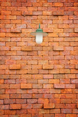 Old red brick wall with street lightの写真素材