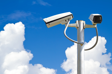 Security camera on blue sky background
