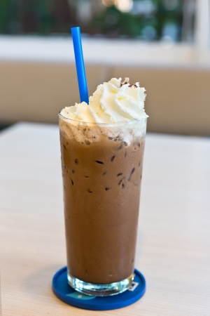 A delicious iced mocha coffee drink topped with fresh whipped creamの写真素材