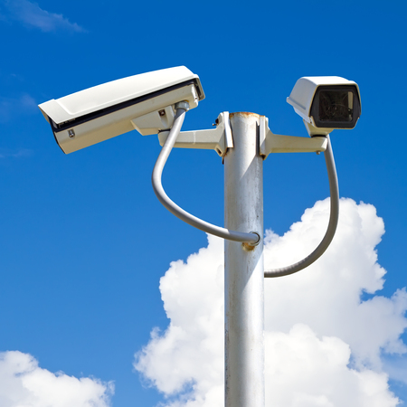 Security camera on blue sky backgroundの写真素材