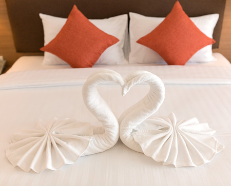 swans made from towels on the bed.の写真素材