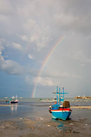 boat by the huahin beachside during beautiful sky with rainbowの写真素材