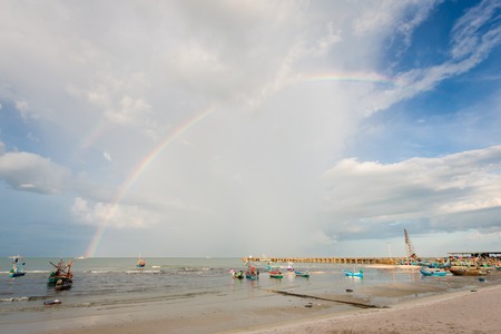 boat by the huahin beachside during beautiful sky with rainbowの写真素材