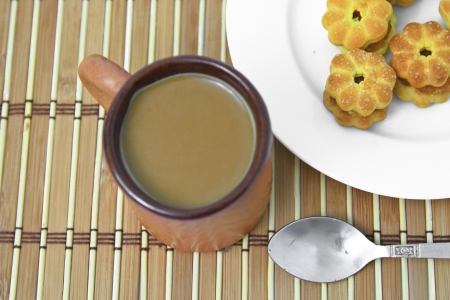 Coffee in brown cup and Pineapple cookies の写真素材