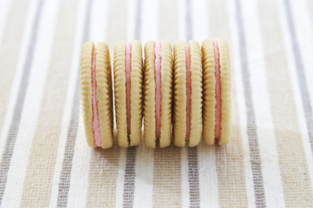 Delicious crackers with strawberry cream on white plate.の写真素材