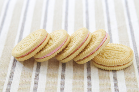 Delicious crackers with strawberry cream on white plate.の写真素材