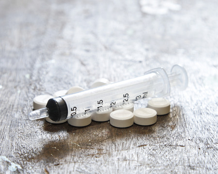 Used syringe on wooden.の写真素材