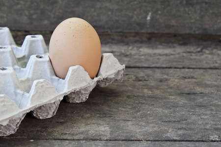 Chicken brown eggs on old wooden.