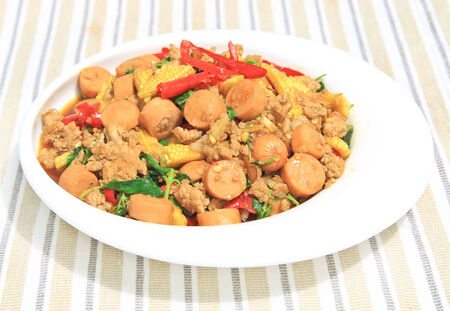 Thai spicy food,stir fried pork and sausage with basil.の写真素材