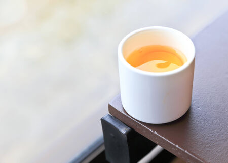 Raw egg in white cup.の写真素材