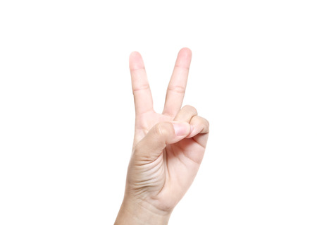 Hand with two fingers up in the peace or victory symbol. Also the sign for the letter V in sign language. Isolated on white.の写真素材